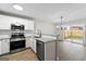 Well-equipped kitchen featuring stainless steel appliances and white cabinets with granite countertops at 89 Prospect Path, Hiram, GA 30141