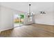 Bright living area with vinyl floors, modern lighting, and sliding glass doors to the backyard at 89 Prospect Path, Hiram, GA 30141