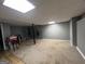 Partially finished basement space with updated flooring, lighting, and storage area at 150 Doe Run Ct, Sharpsburg, GA 30277