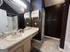 Bathroom with a single sink vanity and shower at 150 Doe Run Ct, Sharpsburg, GA 30277