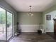 Inviting dining room with wood floors, a sliding glass door and decorative wall trim at 150 Doe Run Ct, Sharpsburg, GA 30277
