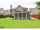 Well-maintained backyard with lawn, mature trees, and a screened in patio, perfect for entertaining at 613 Blackburn Ln, Peachtree City, GA 30269