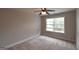 A carpeted bedroom offers ample natural light from a large window at 613 Blackburn Ln, Peachtree City, GA 30269