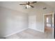 Bedroom with neutral walls, carpeted floor, ceiling fan, closet, and a window overlooking the exterior at 613 Blackburn Ln, Peachtree City, GA 30269