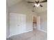 Bedroom featuring neutral walls, carpeted floor, ceiling fan, and double-door closet at 613 Blackburn Ln, Peachtree City, GA 30269