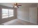 Bright, carpeted bedroom features a ceiling fan and window at 613 Blackburn Ln, Peachtree City, GA 30269