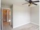 This is a carpeted bedroom with ceiling fan at 613 Blackburn Ln, Peachtree City, GA 30269