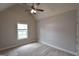 Bedroom with neutral walls, carpeted floor, ceiling fan, and a window overlooking the exterior at 613 Blackburn Ln, Peachtree City, GA 30269