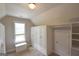 Walk-in closet with custom shelving, storage cabinets and a bench under the window at 613 Blackburn Ln, Peachtree City, GA 30269