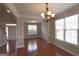 Open dining space with hardwood floors, neutral walls, and chandelier lighting above the dining area at 613 Blackburn Ln, Peachtree City, GA 30269