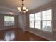 Well-lit dining area with hardwood flooring, neutral walls, with bright light coming through large windows at 613 Blackburn Ln, Peachtree City, GA 30269