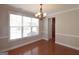 Bright dining room featuring hardwood floors, large windows, and modern light fixture at 613 Blackburn Ln, Peachtree City, GA 30269