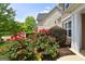 Exterior shot of a home with mature landscaping, flowering bushes, and manicured lawn at 613 Blackburn Ln, Peachtree City, GA 30269