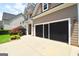 Home exterior featuring a screened garage and landscaped surroundings at 613 Blackburn Ln, Peachtree City, GA 30269