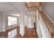 A grand foyer features hardwood floors, staircase, and an open view to adjacent living spaces at 613 Blackburn Ln, Peachtree City, GA 30269