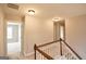 Upstairs hallway featuring carpeted floors, neutral paint, and white banister overlooking the staircase at 613 Blackburn Ln, Peachtree City, GA 30269