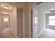 Upstairs hallway with access to multiple rooms, featuring neutral carpeting and bright lighting at 613 Blackburn Ln, Peachtree City, GA 30269