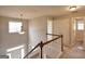Second floor hallway with natural light from windows and a view of the staircase below at 613 Blackburn Ln, Peachtree City, GA 30269