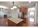 Spacious kitchen featuring a granite island, stainless steel refrigerator, and warm wood cabinets at 613 Blackburn Ln, Peachtree City, GA 30269