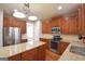 Updated kitchen with stainless steel appliances, granite countertops, and dark wooden cabinetry at 613 Blackburn Ln, Peachtree City, GA 30269