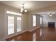 Open-concept living area with fireplace and access to a backyard through glass doors and windows at 613 Blackburn Ln, Peachtree City, GA 30269