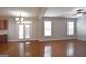 Open-concept living room boasts hardwood floors, and white framed glass doors to the backyard at 613 Blackburn Ln, Peachtree City, GA 30269