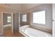 The bathroom features a tiled soaking tub and a separate glass enclosed shower at 613 Blackburn Ln, Peachtree City, GA 30269
