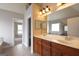 The main bathroom features a double sink vanity with wood cabinets and a large mirror at 613 Blackburn Ln, Peachtree City, GA 30269