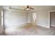 Spacious carpeted main bedroom with neutral colored walls, ceiling fan, and a door leading to the main bathroom at 613 Blackburn Ln, Peachtree City, GA 30269