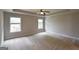 Spacious main bedroom with a tray ceiling and large windows allowing for lots of natural light at 613 Blackburn Ln, Peachtree City, GA 30269