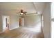 Bright main bedroom with neutral colored walls, a ceiling fan, and several doors leading to other rooms at 613 Blackburn Ln, Peachtree City, GA 30269