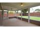 Sunroom features neutral tone walls, concrete floors, windows with screens, and ceiling fans at 613 Blackburn Ln, Peachtree City, GA 30269