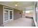 Sunroom features neutral tone walls, concrete floors, windows with screens, ceiling fans, and double doors at 613 Blackburn Ln, Peachtree City, GA 30269