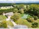 Stunning aerial view of home with a pond and lush greenery in a serene, private setting at 557 Arrowhead Cir, Rutledge, GA 30663