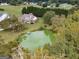 Breathtaking aerial shot of the estate featuring a house with a private pond at 557 Arrowhead Cir, Rutledge, GA 30663
