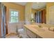 Bright bathroom featuring a single sink vanity, large mirror, and a window for natural light at 557 Arrowhead Cir, Rutledge, GA 30663
