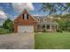 Charming front exterior with a well-manicured lawn and inviting entrance at 557 Arrowhead Cir, Rutledge, GA 30663