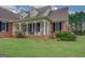 Inviting front porch with white columns and brick accents, creating a welcoming entrance at 557 Arrowhead Cir, Rutledge, GA 30663