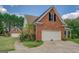 Spacious garage and exterior brick detail create an appealing and functional design at 557 Arrowhead Cir, Rutledge, GA 30663
