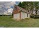 Detached garage with brick and siding, offering ample storage and parking space at 557 Arrowhead Cir, Rutledge, GA 30663