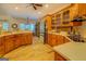 Warm kitchen featuring wood cabinets, ample countertop space, and natural light at 557 Arrowhead Cir, Rutledge, GA 30663