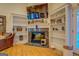 Living area boasts a marble fireplace, custom shelving, and a mounted TV creating a cozy and stylish retreat at 557 Arrowhead Cir, Rutledge, GA 30663