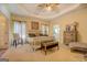 Spacious main bedroom features a large bed, tray ceilings, and carpet at 557 Arrowhead Cir, Rutledge, GA 30663