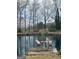 Picturesque pond with a private dock and seating area, ideal for relaxation at 557 Arrowhead Cir, Rutledge, GA 30663