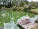 Scenic view of the pond with a dock and seating area for enjoying the outdoors at 557 Arrowhead Cir, Rutledge, GA 30663