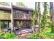 Backyard showing a multi-tiered deck with a wooded lot, ideal for relaxation and gatherings at 65 Cobblestone Crk, Peachtree City, GA 30269
