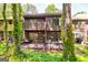 Backyard with a multi-level deck and a wooded view, perfect for outdoor entertaining at 65 Cobblestone Crk, Peachtree City, GA 30269