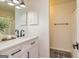 Modern bathroom featuring vanity with marbled top, decorative mirror and shower with a tub at 65 Cobblestone Crk, Peachtree City, GA 30269