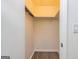 Walk-in closet with hanging racks and shelves, providing ample storage space and wood floors at 65 Cobblestone Crk, Peachtree City, GA 30269
