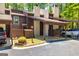 Well-maintained townhouse exterior featuring a covered parking and a manicured lawn at 65 Cobblestone Crk, Peachtree City, GA 30269